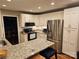 This is a kitchen with stainless steel appliances, granite countertops, and a breakfast bar at 16134 Tinura Ct # 134, Tega Cay, SC 29708