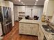 A spacious kitchen featuring an island, white cabinetry, and stainless steel appliances at 16134 Tinura Ct # 134, Tega Cay, SC 29708