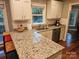 This is a kitchen with granite countertops, stainless steel appliances, and a view of the backyard at 16134 Tinura Ct # 134, Tega Cay, SC 29708