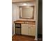 A stylish wet bar with a stainless steel mini fridge, a sink, and a decorative mirror above at 16134 Tinura Ct # 134, Tega Cay, SC 29708