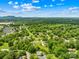 Beautiful aerial view showcases the neighborhood's lush, verdant tree canopy and setting against a bright blue sky at 1811 Belmar Dr, Gastonia, NC 28052