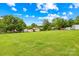 Expansive backyard featuring a large, well-maintained lawn, storage sheds, and mature trees, offering plenty of space and privacy at 1811 Belmar Dr, Gastonia, NC 28052