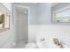 All-white bathroom featuring shower stall, toilet and small sink at 1811 Belmar Dr, Gastonia, NC 28052