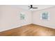 Comfortable bedroom featuring hardwood floors and natural light from two windows at 1811 Belmar Dr, Gastonia, NC 28052