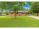 Charming one-story brick home featuring a cozy front porch, covered side entrance, and a spacious front yard at 1811 Belmar Dr, Gastonia, NC 28052