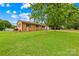 Charming one-story brick home featuring a cozy front porch, covered side entrance, and a well-maintained front yard at 1811 Belmar Dr, Gastonia, NC 28052