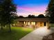Charming brick home features a covered parking area, well-kept lawn, and mature trees at 1811 Belmar Dr, Gastonia, NC 28052