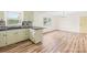 Modern kitchen with stylish flooring, white cabinets, and plenty of natural light and backyard views at 1811 Belmar Dr, Gastonia, NC 28052