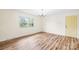Bright living area with new flooring, a large window and a sunny yellow front door at 1811 Belmar Dr, Gastonia, NC 28052