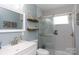 Bathroom showcasing updated shower with glass door, white vanity, tile flooring and coordinated fixtures and decor at 192 Bailey Ave, Rock Hill, SC 29732