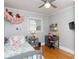 Bright bedroom featuring hardwood floors, neutral tones, ceiling fan, decor and a dedicated study space at 192 Bailey Ave, Rock Hill, SC 29732