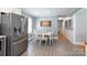 Bright dining area adjacent to the kitchen, with white table and chairs, and a stainless steel refrigerator at 192 Bailey Ave, Rock Hill, SC 29732