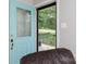 View from inside showing the bright blue front door with decorative glass and view to a grassy front yard at 192 Bailey Ave, Rock Hill, SC 29732