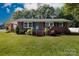Charming red brick home with manicured lawn and landscaped garden beds, featuring a bright blue front door at 192 Bailey Ave, Rock Hill, SC 29732