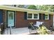 Charming brick home featuring a cozy front porch with seating and a well-maintained landscaped yard at 192 Bailey Ave, Rock Hill, SC 29732