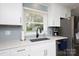 Bright kitchen area showcasing white cabinetry, modern fixtures, and a view through the window at 192 Bailey Ave, Rock Hill, SC 29732