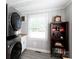 Functional laundry area with stacked washer/dryer, shelving, and a window for natural light at 192 Bailey Ave, Rock Hill, SC 29732