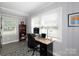 Bright office space featuring wood desk, large windows, neutral tones, and shelving for a cozy and productive work environment at 192 Bailey Ave, Rock Hill, SC 29732