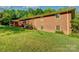 Large backyard with lush lawn and mature trees providing privacy for the beautiful brick home at 211 Amos Homesley Rd, Cherryville, NC 28021