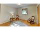 Cozy bedroom featuring hardwood floors, neutral walls, and natural light from the window with floral curtains at 211 Amos Homesley Rd, Cherryville, NC 28021