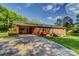 Charming brick home with a long driveway, green lawn, and a covered patio area perfect for entertaining at 211 Amos Homesley Rd, Cherryville, NC 28021