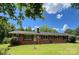Charming one story brick home with a well-manicured lawn and mature trees at 211 Amos Homesley Rd, Cherryville, NC 28021