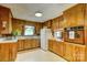 Functional kitchen with wood cabinetry, white countertops, and vintage appliances at 211 Amos Homesley Rd, Cherryville, NC 28021