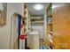 Functional laundry area with washer, dryer, shelves, and plenty of room for storage at 211 Amos Homesley Rd, Cherryville, NC 28021