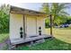 Exterior view of an outbuilding with a covered porch and decorative potted plants at 211 Amos Homesley Rd, Cherryville, NC 28021