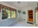 Sunroom with brick-painted walls, and patterned floors, featuring windows looking out to the backyard at 211 Amos Homesley Rd, Cherryville, NC 28021