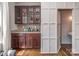 Stylish bar area features custom cabinetry, granite countertop, and mosaic tile backsplash at 2125 Belle Vernon Ave, Charlotte, NC 28210