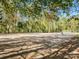 Outdoor basketball court surrounded by mature trees, providing a scenic and active recreation space for residents and visitors at 2125 Belle Vernon Ave, Charlotte, NC 28210