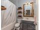 This bathroom has a shower/tub combo, single vanity, and stylish decor to enhance your daily routine at 2125 Belle Vernon Ave, Charlotte, NC 28210