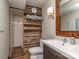 Bathroom featuring modern vanity, decorative mirror, and shower with white subway tile at 2125 Belle Vernon Ave, Charlotte, NC 28210