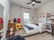 Cozy bedroom featuring unique decor, a ceiling fan, and a bright window for natural light at 2125 Belle Vernon Ave, Charlotte, NC 28210