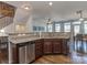 Open concept kitchen with breakfast bar, stainless steel appliances, and dining area at 2125 Belle Vernon Ave, Charlotte, NC 28210