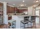 Open kitchen view features a breakfast bar, stainless appliances, and wood cabinets at 2125 Belle Vernon Ave, Charlotte, NC 28210