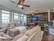 Open-concept living room features modern wood accent wall, dining area, and comfortable sectional sofa at 2125 Belle Vernon Ave, Charlotte, NC 28210