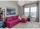 Bright living room featuring a pink couch, large windows, and modern chandelier at 2125 Belle Vernon Ave, Charlotte, NC 28210