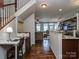 Open floor plan with hardwood floors, a staircase, an integrated desk, and living room area at 2125 Belle Vernon Ave, Charlotte, NC 28210