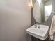 Modern powder room features pedestal sink, decorative mirror, and updated lighting at 2125 Belle Vernon Ave, Charlotte, NC 28210
