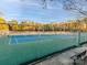 Community tennis courts offering a recreational amenity with fenced courts and a viewing bench for residents and visitors alike at 2125 Belle Vernon Ave, Charlotte, NC 28210