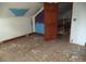 Attic with hard wood floors and view of stairs at 216 N Rowan Ave, Spencer, NC 28159