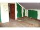 Unfinished bedroom featuring hardwood floors and a door leading to another room at 216 N Rowan Ave, Spencer, NC 28159