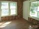 Bedroom in the process of renovation, exposing insulation and framing near windows at 216 N Rowan Ave, Spencer, NC 28159