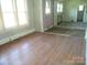 Bright living room featuring hardwood floors and large windows providing ample natural light at 216 N Rowan Ave, Spencer, NC 28159