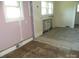 A fixer-upper living room with hardwood floors and natural light, ready for renovation at 216 N Rowan Ave, Spencer, NC 28159