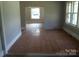 Partially renovated living room with hardwood floors and an open floor plan at 216 N Rowan Ave, Spencer, NC 28159