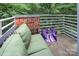 Cozy balcony with green cushioned seating and brick accents, surrounded by leafy foliage at 226 Magnolia Ave, Charlotte, NC 28203