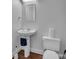Compact bathroom boasts a pedestal sink, toilet, and decorative mirror in a neutral color scheme at 226 Magnolia Ave, Charlotte, NC 28203